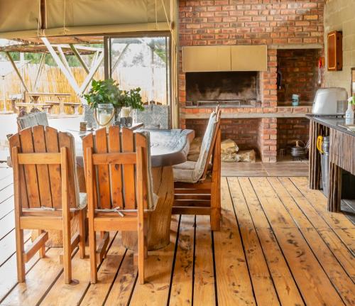 a kitchen and dining room with a table and chairs at Klein Plekkie Self Catering Accommodation in Addo