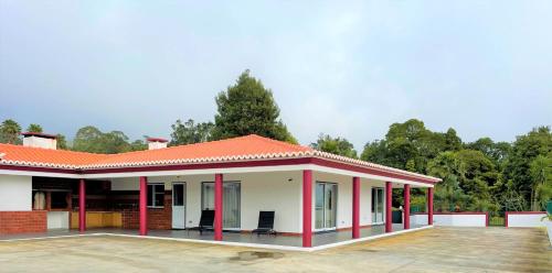 a small house with a red roof at Chalé d'Angra Guest House in Angra do Heroísmo