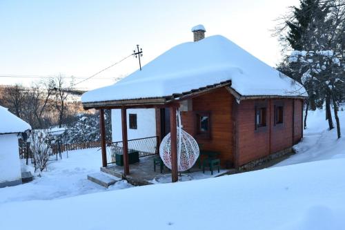 a small cabin with snow on top of it at Mijatov Konak in Zlatibor