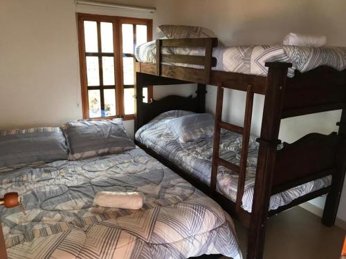 a bedroom with two bunk beds and a window at Cabañas San Miguel Arcángel in San Gil