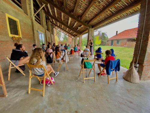 a group of children sitting in chairs in a building at La Fornace in Alessandria