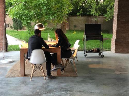 a man and woman sitting at a table with a piano at La Fornace in Alessandria