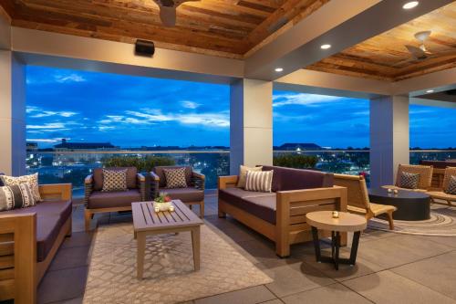a patio with couches and tables and large windows at Hyatt Place Fort Worth/TCU in Fort Worth