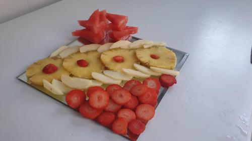 a plate of food with fruit and berries on a table at H La Cabaña in Pozuelo de Alarcón