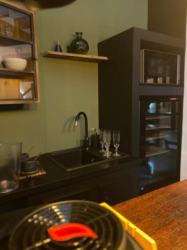 a kitchen with a sink and a counter top at Pasithéa Loft Spa Privatif in Calais