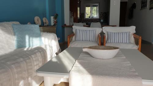 a white table with two chairs and a bowl on it at Alma Maisonette in Kavala