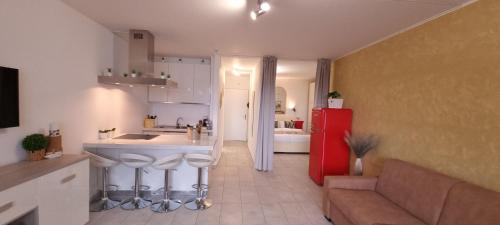 a kitchen with a red refrigerator and a couch at Relax-Lugano Lake in Bissone