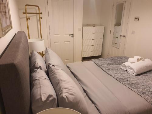 a bedroom with a bed with pillows on it at The Joyland House in Romsey