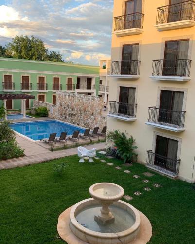 a large building with a fountain in the middle of a yard at Real Hispano in Valladolid