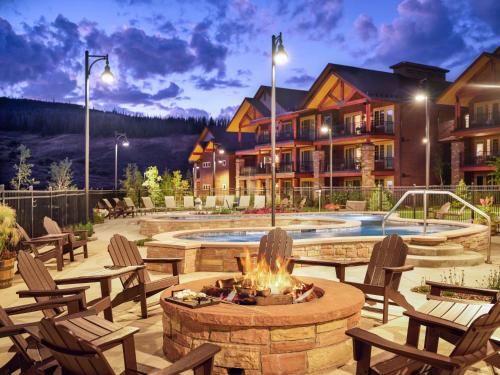 a patio area with a fire place, chairs and tables at The Ranahan by Vacation Club Rentals in Breckenridge