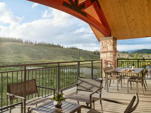 a patio with a table and chairs on a deck at Hyatt Vacation Club at The Ranahan in Breckenridge