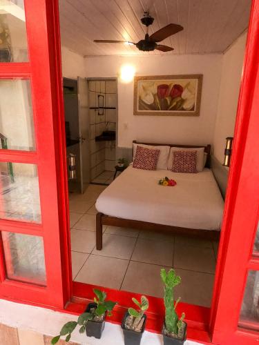 a view of a bedroom with a bed and a mirror at Leo's Clan Beach Hostel in Paraty