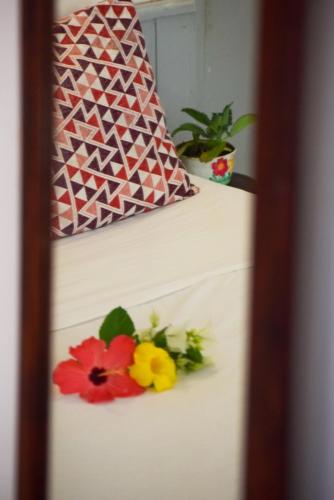 a white cake with flowers on top of it at Leo's Clan Beach Hostel in Paraty
