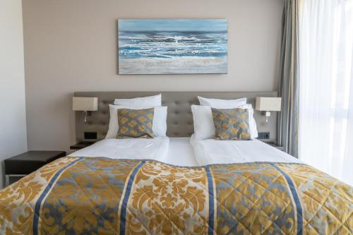 a bedroom with a large bed with two pillows at Hotel Swiss Star in Wetzikon