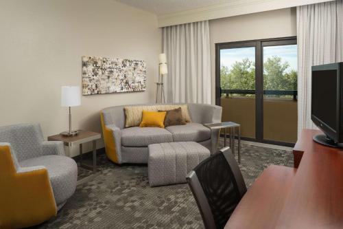 a living room with a couch and a chair at Sonesta Select Miami Lakes in Miami Lakes