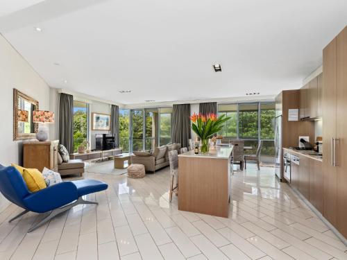 a living room with a blue chair and a blue couch at Salt Beach Luxury Apartments by Kingscliff Accommodation in Kingscliff