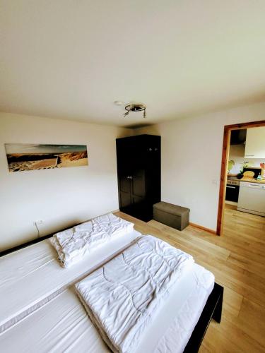 a bedroom with a large white bed in a room at Ferienwohnung Walfisch inkl Strandkorb in Göhren