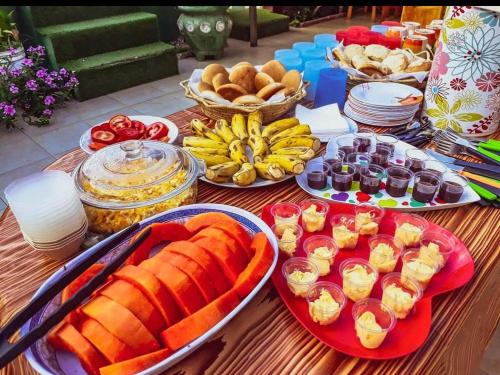 a table with different types of food on it at El Curichal Hostel in Rurrenabaque