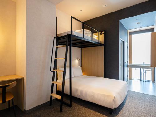 a bedroom with a bunk bed with a ladder at Akabane Holic Hotel in Tokyo