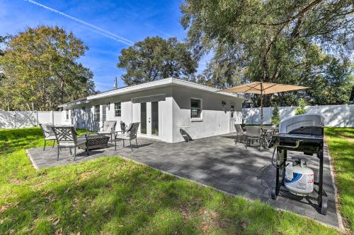 a backyard with a grill and a house at Chic Home with Fire Pit and Patio, Walk to Lake! in Dublin