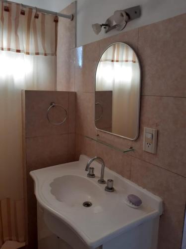 a bathroom with a sink and a mirror at SOL Y LUNA in Huerta Grande