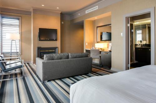 a hotel room with a bed and a couch at Hotel Arts Kensington in Calgary