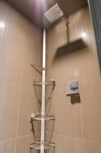 a shower with a white pole in a room at Hotel Arts Kensington in Calgary