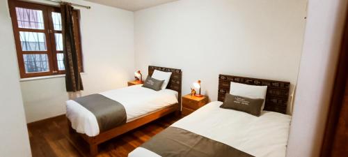 Ліжко або ліжка в номері 7th Wonder Apart Hotel Cusco