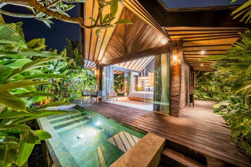 a pool in the middle of a house with plants at Desa Hay Canggu in Canggu