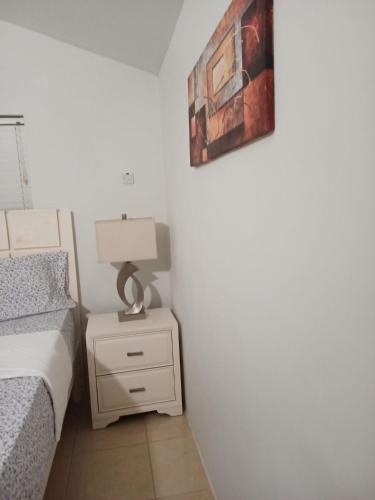 a bedroom with a bed and a lamp on a night stand at Joy Estate Rooftop Pool n View unit #1 in Falmouth