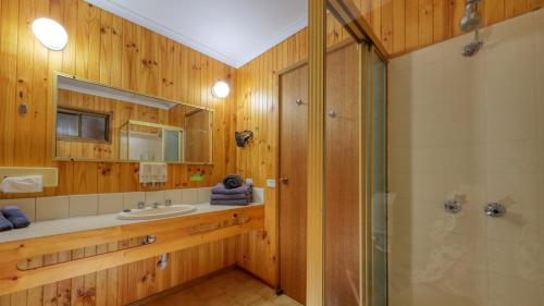 a bathroom with a sink and a shower at Country Roads Motor Inn in Narrandera