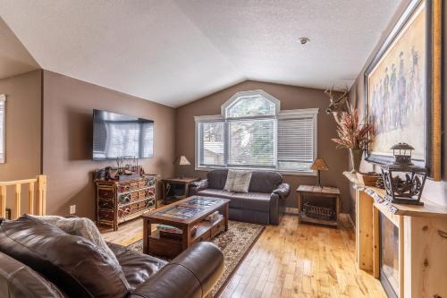 a living room with a couch and a table at The Magnificent 7 in Columbia Falls