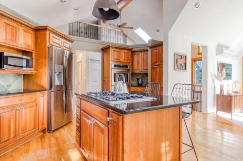 a kitchen with wooden cabinets and a stove top oven at Hood Hideaway in Welches