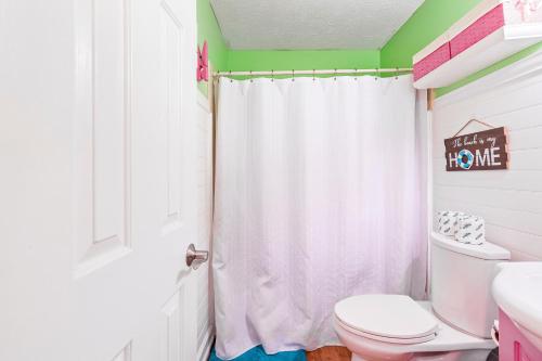 a bathroom with a toilet and a shower curtain at Cherry Grove 26 in Myrtle Beach
