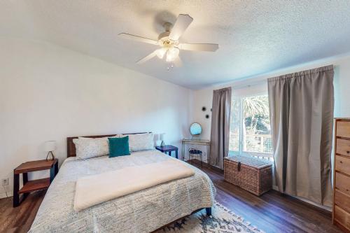 a bedroom with a bed and a ceiling fan at Serenity in Port Orford