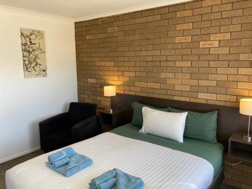 Postel nebo postele na pokoji v ubytování Camellia Motel