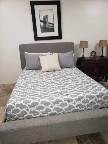 a bedroom with a bed with a gray comforter at Brothers Townhouse Puerto Peñasco, Centro in Puerto Peñasco