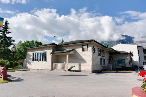a small white building with a parking lot at The Drake Inn in Canmore