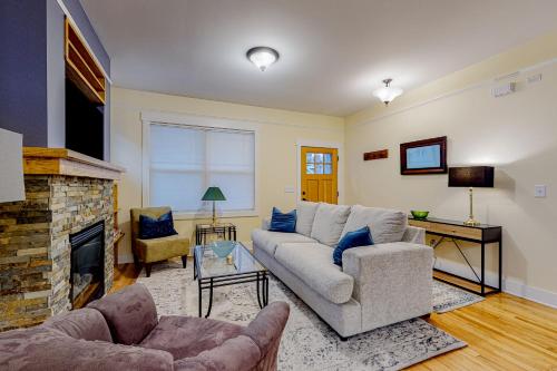 a living room with a couch and a fireplace at Brydcliffe Butte in Asheville