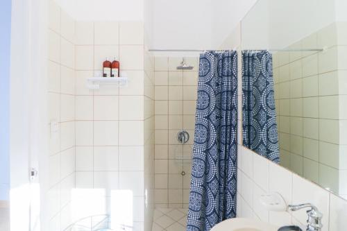 a bathroom with a shower with a toilet and a sink at Villaggio Claudia 29B in Potrero