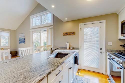 a kitchen with a sink and a counter top at Seabury Serenity in New Seabury