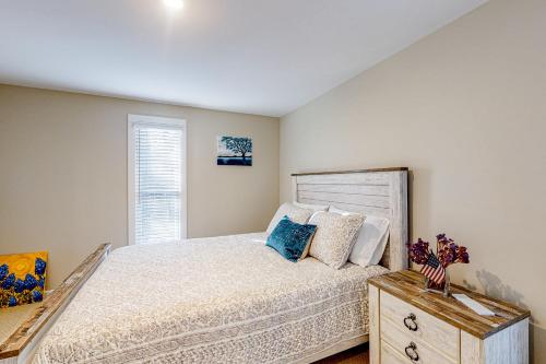 a bedroom with a large bed and a window at Seabury Serenity in New Seabury