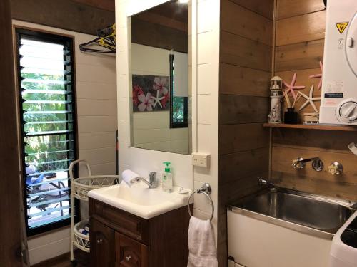 a bathroom with a sink and a mirror and a sink at Beach-Villa 4 in South Mission Beach