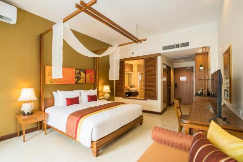 a bedroom with a bed and a living room at Cosy Beach Hotel - SHA Extra Plus in Pattaya South