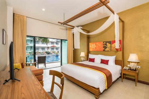 a bedroom with a bed and a desk and a television at Cosy Beach Hotel - SHA Extra Plus in Pattaya South