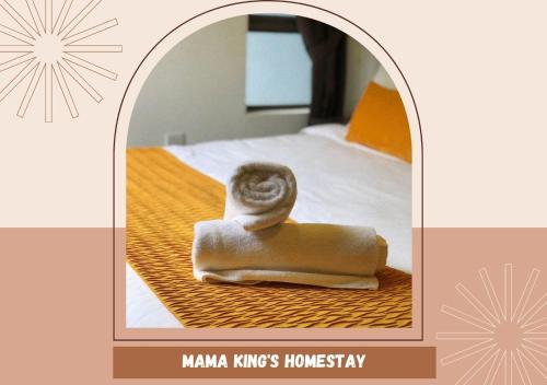 a picture of a towel sitting on a bed at Mama King’s Homestay@ Palas Horizon in Brinchang