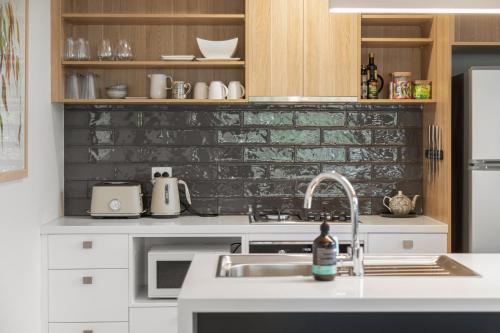 a kitchen with a sink and a counter top at City Courtyard One Apartment in Mount Gambier