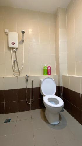a bathroom with a toilet and a shower at Simfoni Families Suite in Kuah