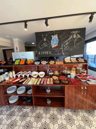 a coffee shop with a counter full of food at Nomade Old City Hotel in Istanbul