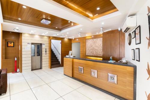 a lobby of a hotel with a reception desk at Hotel Ashish in Ahmedabad